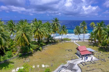 White and Red House Near Sea