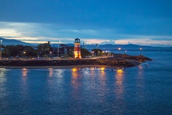 White and Red Lighthouse Near Body of Water