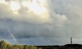 White and Red Lighthouse on Far Right and Rainbow on Far Left