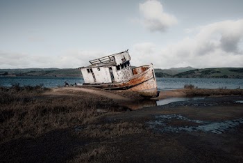 White and Rusty Boat on Seashore