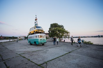 White and Teal Van Surrounded With People