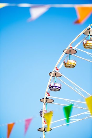 white and yellow Ferris wheel under blue skies photo
