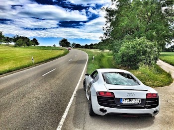 White Audi Coupe on Gray Concrete Road during Textile