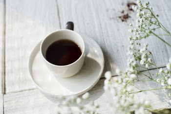 White Baby's Breath Flowers Beside White Cup