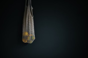 white basket with round yellow fruits inside of it
