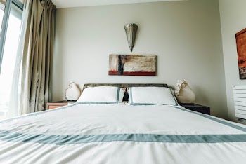 White Bed With Bedspread Near Window