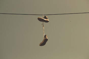 White Black High Top Shoes Hanging on Electric Line