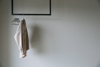 White Blazer Hanging on Black Metal Rack