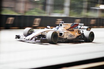 white, blue, and red formula one vehicle