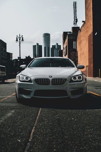 white BMW car on road