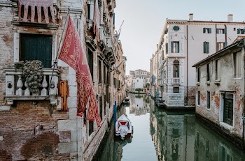white boat beside concrete building