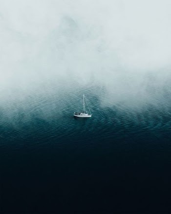 white boat floating on body of water