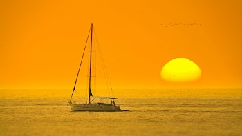 White Boat In The Middle Of The Sea During Sunset