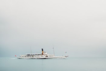 white boat on body of water during daytime