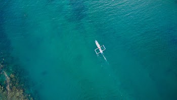 White Boat on Green Body of Water during Daytime