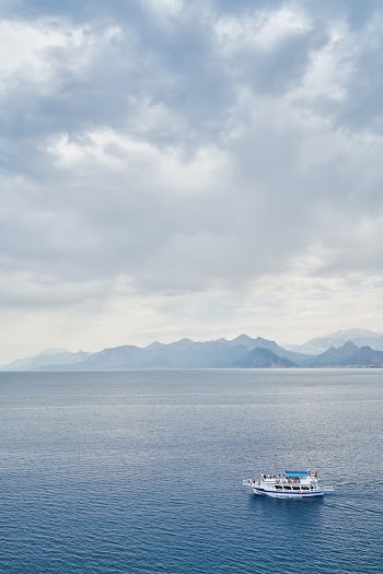 White Boat on Ocean Water during Cloudy Day