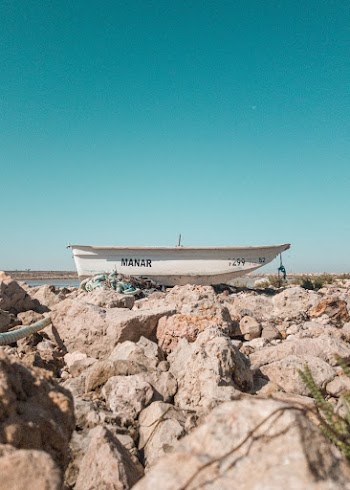 White Boat on Rocks
