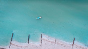 white boat on water at daytime