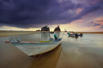 White Boat Park on Seashore Under Gray Sky