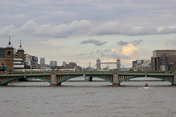 White Boat Passing Under Bridge