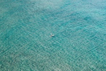 white boat sailing on body of water