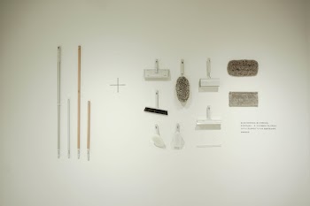 White Brushes and Mops on White Surface