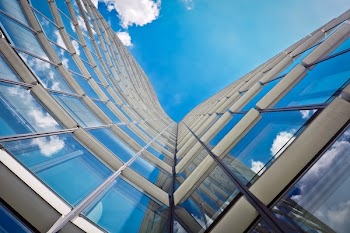 White Building Under Clear Blue Sky in Worms Eye View Photography
