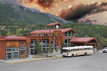 White Bus Parked Beside Wooden Building