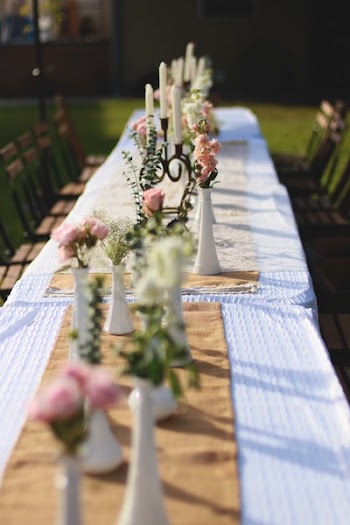 White Candle Holder on Brown Tablecloth Taken at Daytime