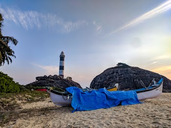 White Canoe With Blue Cover on Sand