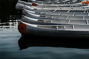 white canoes on body of water during daytime