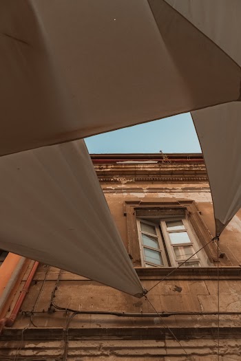 White Canopy Tied on Brown Building