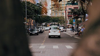 White Car on Road Between Trees