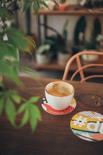 White Ceramic Cup On Brown Wooden Table
