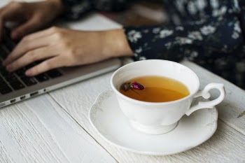 White Ceramic Cup With Brown Liquid on Brown Wooden Table