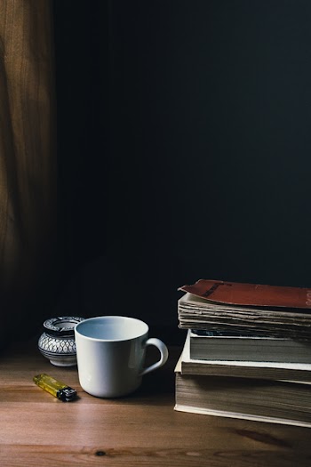White Ceramic Mug and Yellow Disposable Lighter