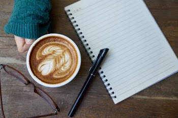 White Ceramic Mug Beside Ballpoint Pen