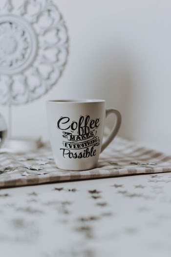 White Ceramic Mug on Gray Cloth