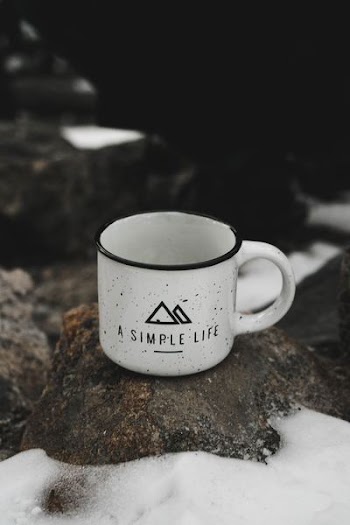 white ceramic mug on rack