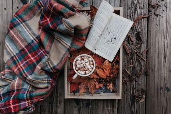 white ceramic mug on top of brown Maple leaf inside tray