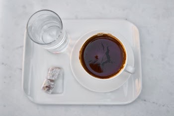 White Ceramic Mug on White Saucer Full With Brown Liquid