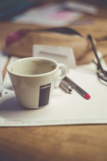 White Ceramic Mug on White Table Near Grey Pen