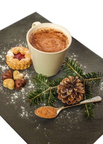 White Ceramic Mug With Brown Liquid and Pine Cone