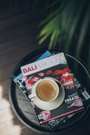 White Ceramic Mug With Filled Coffee on Magazine Book