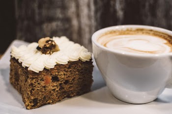 White Ceramic Teacup Near Baked Bread