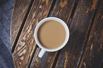White Ceramic Teacup on Brown Wooden Table