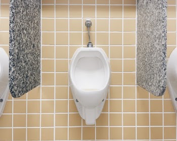 White Ceramic Urinal Toilet Mounted on Tiled Wall