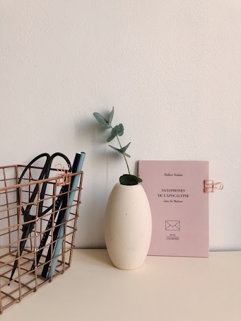 White Ceramic Vase Near Brown Metal Case