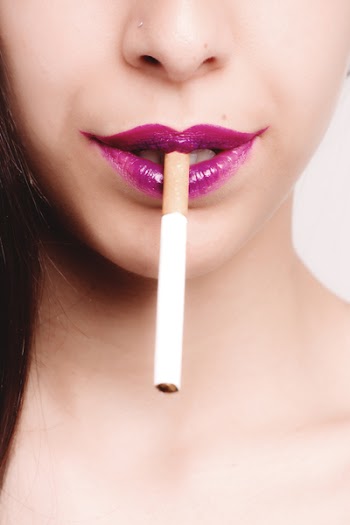White Cigarette Stick on Woman's Mouth