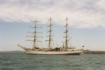 White Clipper Ship on Ocean Under Cloudy Sky